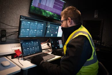 Man looking using SwarmCore technology on computer screens