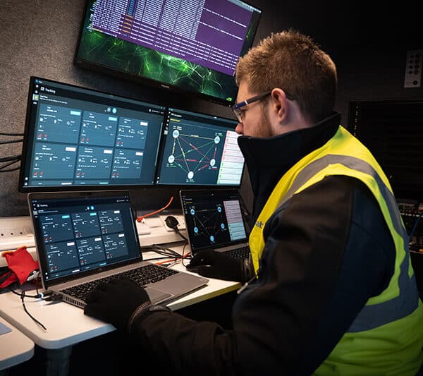 Man looking using SwarmCore technology on computer screens