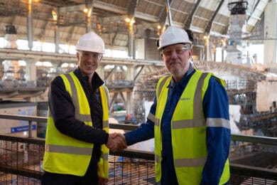 Capt Dan Peskett and Assistant Chief Engineer Tony Cox shaking hands inside Babcock's frigate support centre