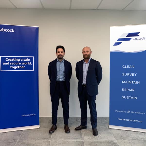 Representatives from Babcock and Franmarine standing in front of company banners