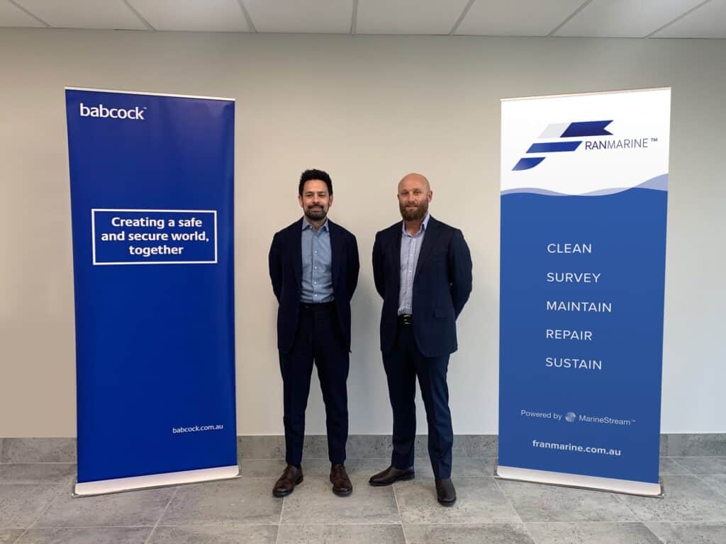 Representatives from Babcock and Franmarine standing in front of company banners
