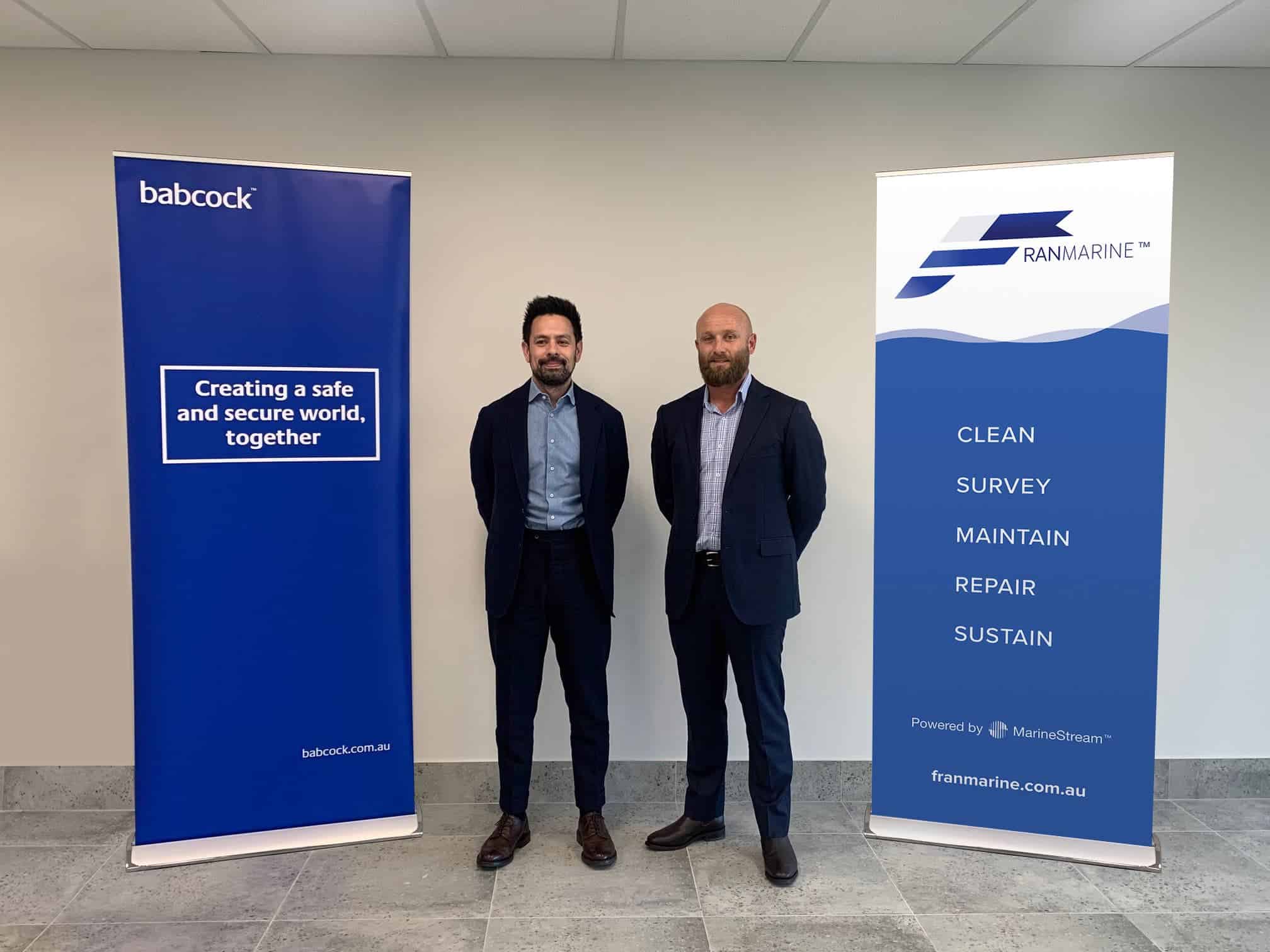Representatives from Babcock and Franmarine standing in front of company banners