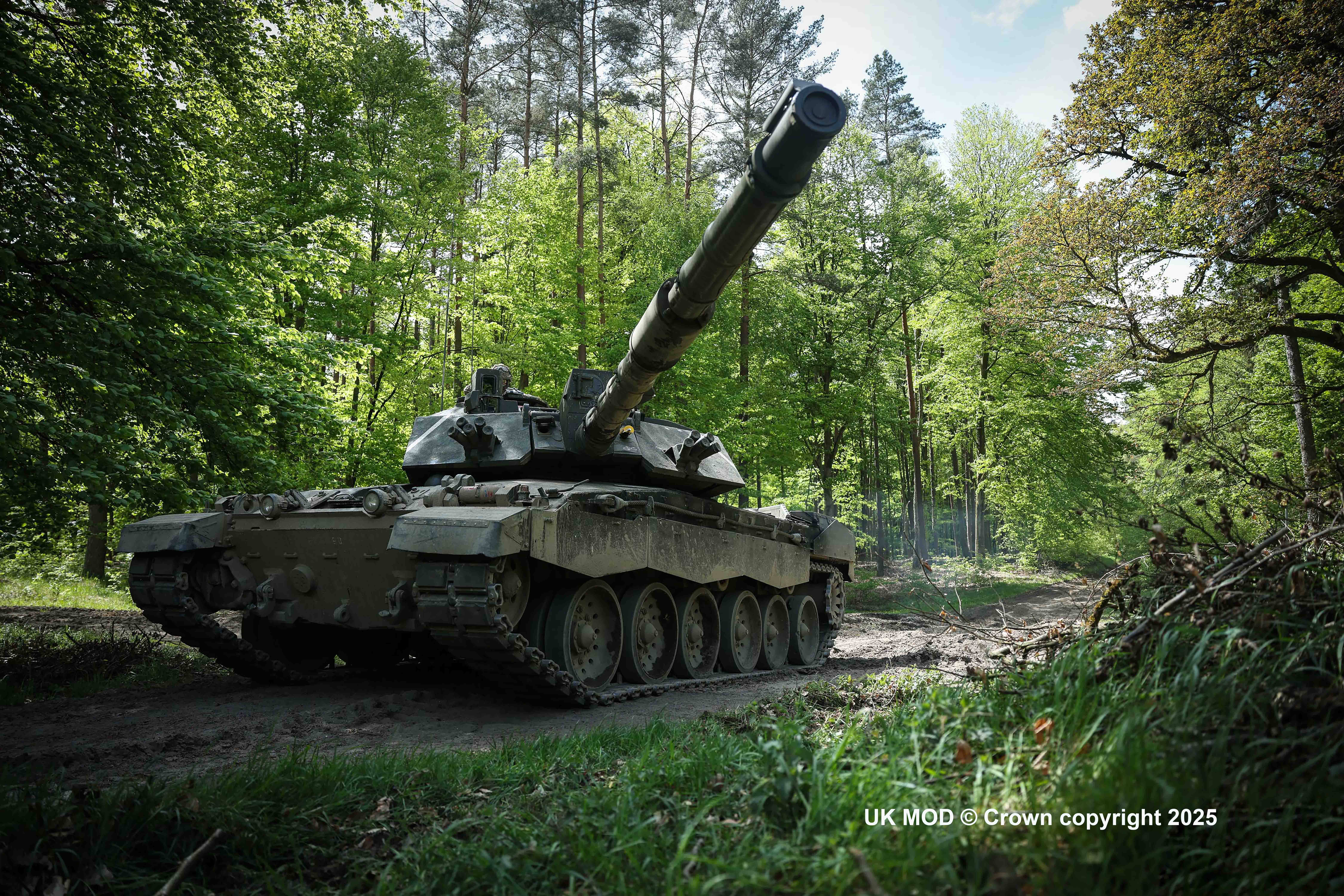 A Challenger 2 Main Battle Tank with Babcock engineering support in a wood|A Challenger 2 Main Battle Tank in a wood