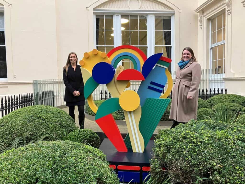 louise and Alice Kan Louise Atkinson and Alice Kan stand behind a colourful sculpture outside the Royal Academy of Engineering