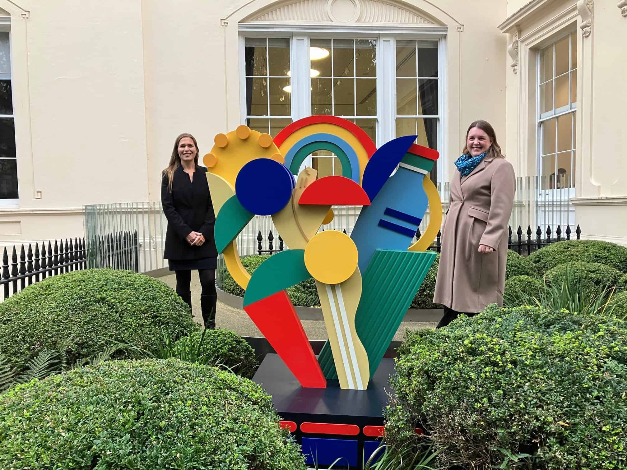 |Louise Atkinson and Alice Kan stand behind a colourful sculpture outside the Royal Academy of Engineering