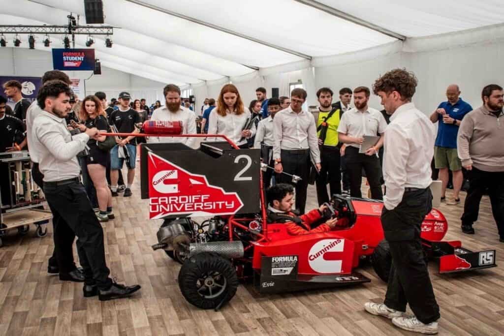 Students with racing car at Formula Student 2025