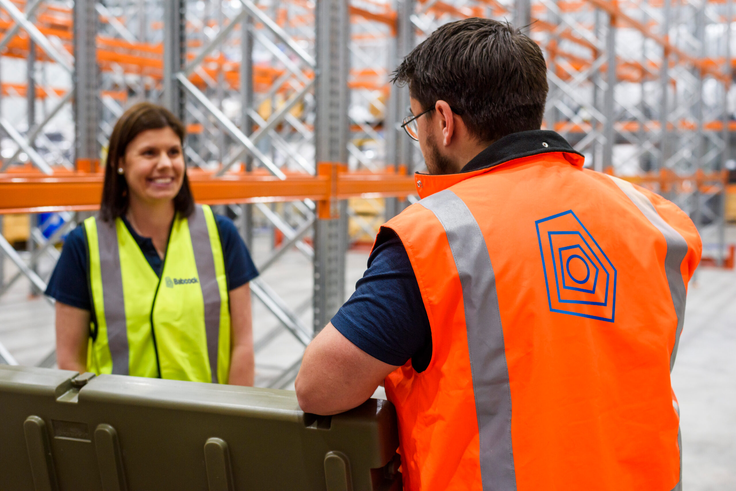 Two Babcock staff in hi vis ensuring staff feel energised, resilient, and ready to be their best every day